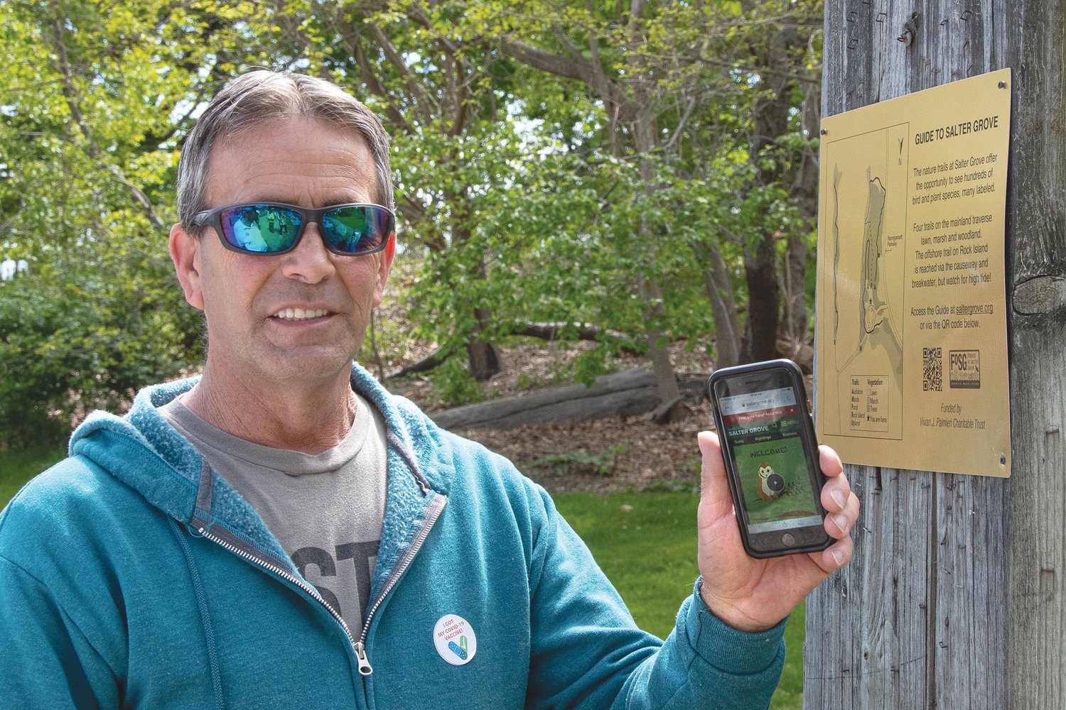 EASY TO USE: Warwick Mayor Frank Picozzi demonstrates how to access the digital guide from your smartphone by using the QR code on the orientation post at the entrance to the park. (Courtesy of Jason Major)